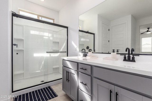 bathroom featuring a stall shower, tile patterned floors, a sink, and double vanity