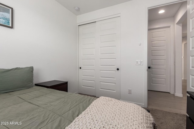 bedroom with a closet and baseboards