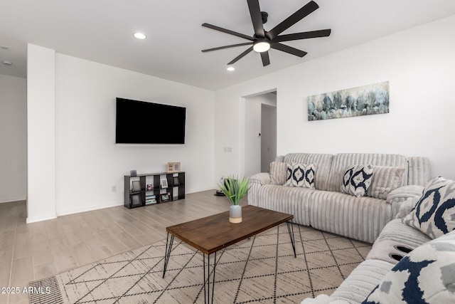 living room with visible vents, baseboards, ceiling fan, wood finished floors, and recessed lighting