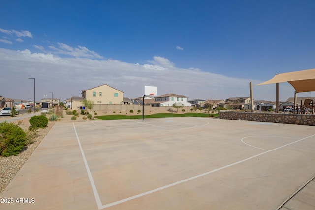 view of basketball court with community basketball court, fence, and a residential view