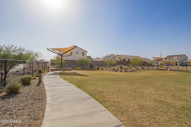 view of yard featuring a residential view and fence