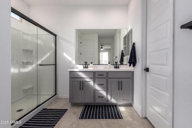 bathroom with a sink, double vanity, and a shower stall