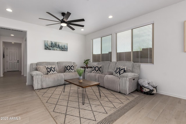 living room with wood tiled floor, visible vents, baseboards, and recessed lighting