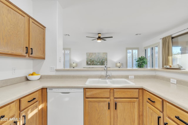 kitchen featuring light brown cabinetry, ceiling fan, dishwasher, and sink