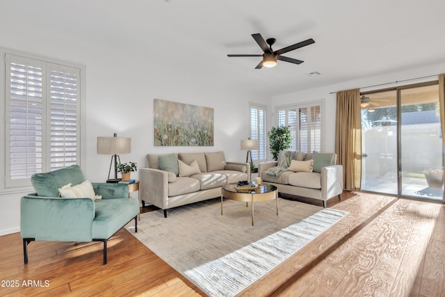 living room with ceiling fan, hardwood / wood-style floors, and a wealth of natural light