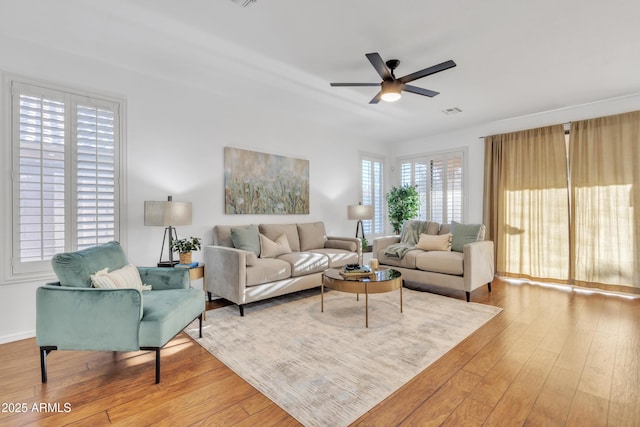 living room with ceiling fan and hardwood / wood-style flooring