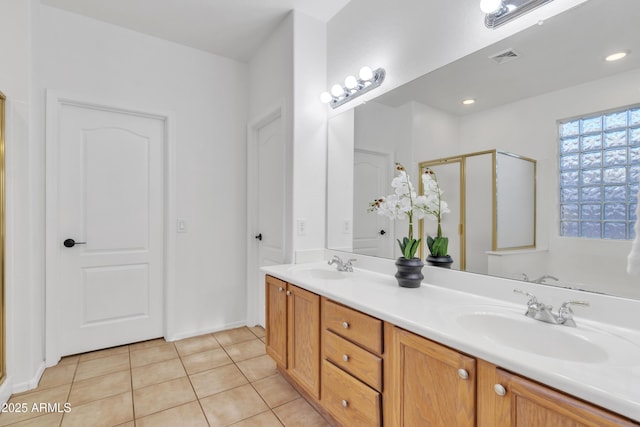 bathroom featuring an enclosed shower, tile patterned flooring, and vanity