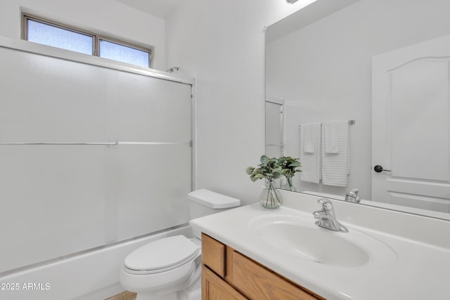 full bathroom featuring toilet, vanity, and combined bath / shower with glass door