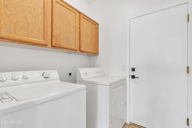 washroom with cabinets and separate washer and dryer