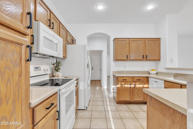 kitchen with white appliances and light tile patterned floors