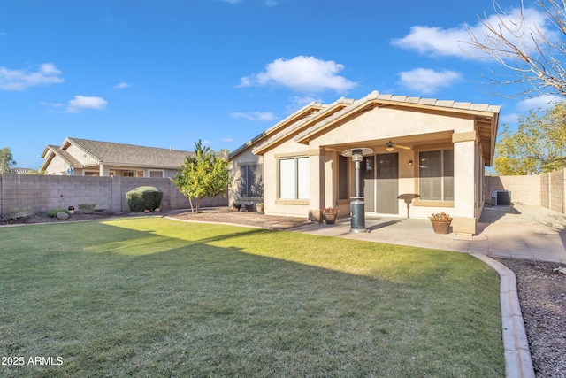 rear view of property featuring a patio area, central AC unit, and a yard