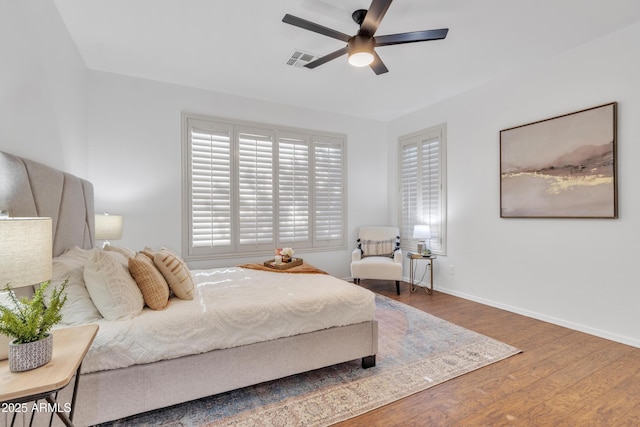 bedroom with ceiling fan and hardwood / wood-style flooring