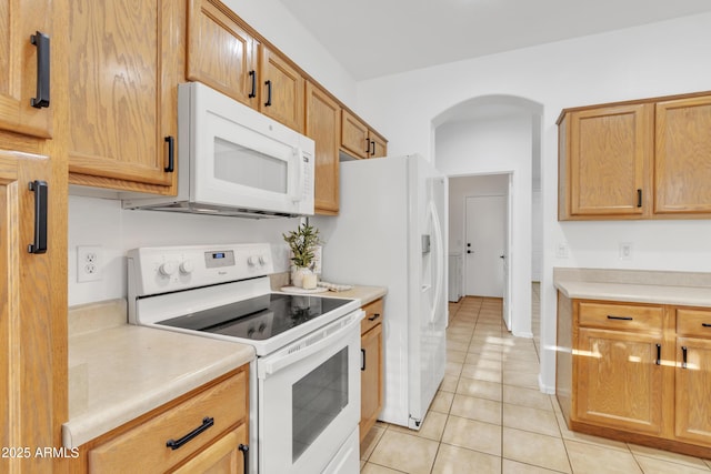 kitchen featuring white appliances and light tile patterned floors