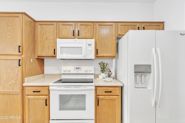 kitchen with white appliances and light brown cabinets