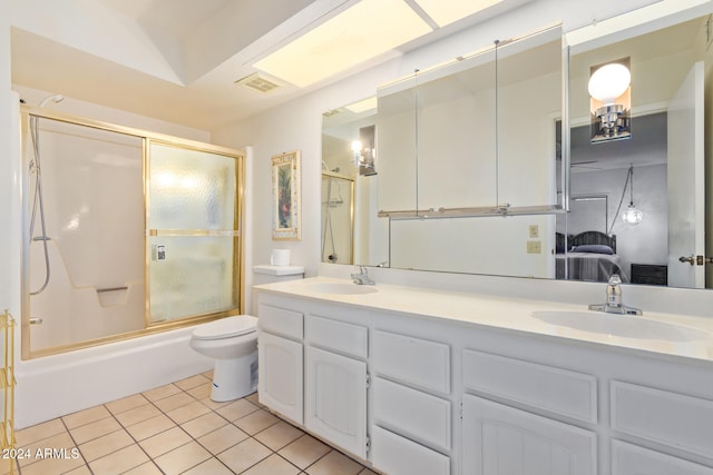 full bathroom featuring tile patterned floors, vanity, toilet, and shower / bath combination with glass door