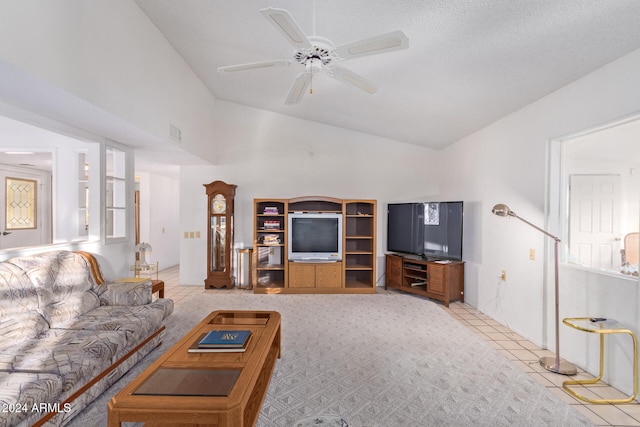 tiled living room featuring ceiling fan, a textured ceiling, and vaulted ceiling