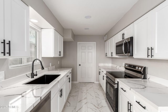 9105 N 13th St, Phoenix, AZ 85020 - kitchen featuring light stone counters, marble finish floor, stainless steel appliances, and a sink