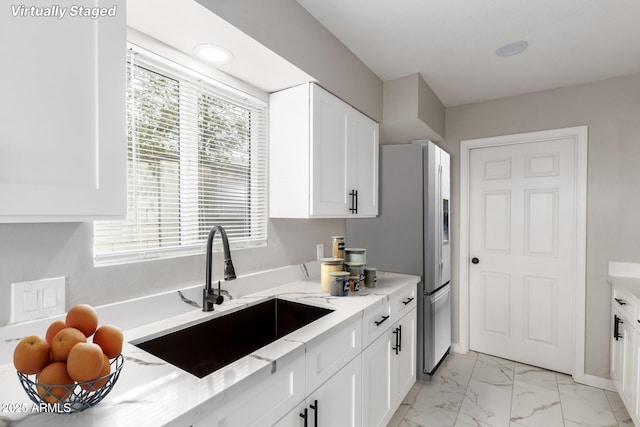 9105 N 13th St, Phoenix, AZ 85020 - kitchen with light stone counters, stainless steel fridge, marble finish floor, white cabinetry, and a sink