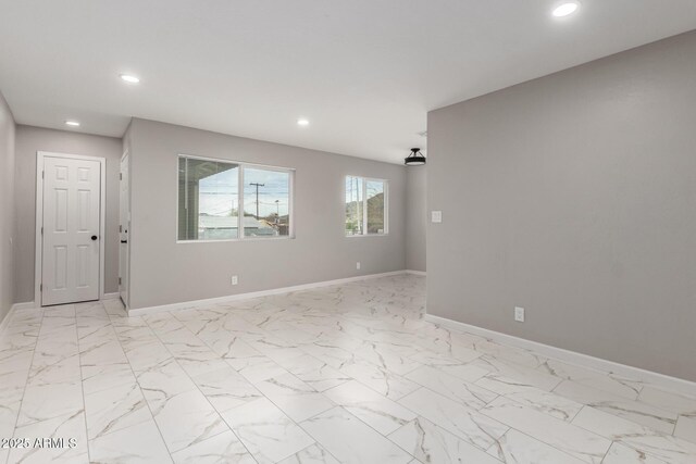 9105 N 13th St, Phoenix, AZ 85020 - empty room featuring recessed lighting, marble finish floor, and baseboards