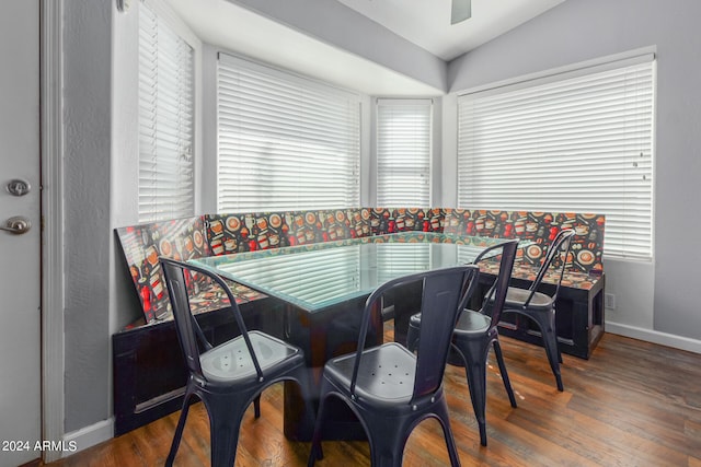 dining area with ceiling fan, hardwood / wood-style floors, vaulted ceiling, and a wealth of natural light