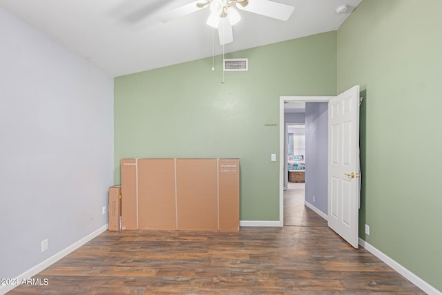 unfurnished bedroom with ceiling fan, lofted ceiling, and dark hardwood / wood-style floors