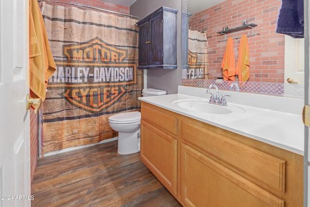 bathroom with hardwood / wood-style floors, vanity, toilet, and curtained shower