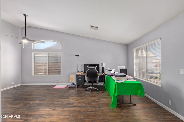 home office featuring dark hardwood / wood-style floors, vaulted ceiling, and ceiling fan