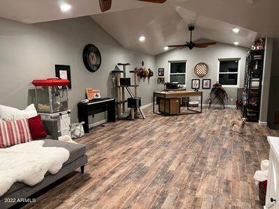 office featuring hardwood / wood-style flooring, ceiling fan, and vaulted ceiling