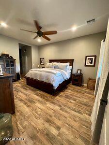 bedroom featuring hardwood / wood-style floors and ceiling fan