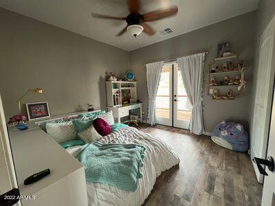 bedroom featuring wood-type flooring, ceiling fan, french doors, and access to exterior