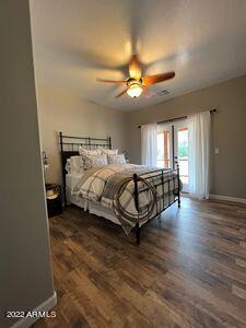 bedroom featuring ceiling fan and dark hardwood / wood-style floors