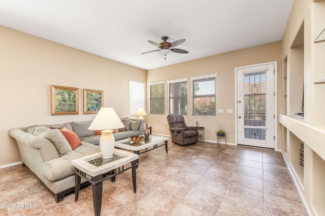 tiled living room with ceiling fan