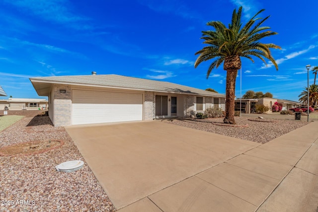 ranch-style home with driveway, brick siding, and an attached garage