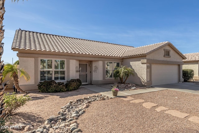 mediterranean / spanish-style home with a garage