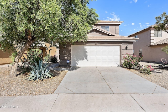 view of front of property with a garage and concrete driveway