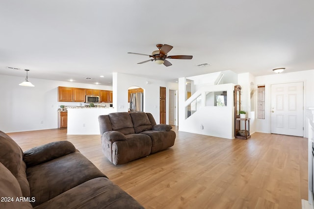 living room with ceiling fan, recessed lighting, visible vents, stairway, and light wood-type flooring