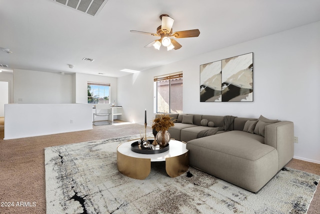 carpeted living room featuring a ceiling fan and visible vents