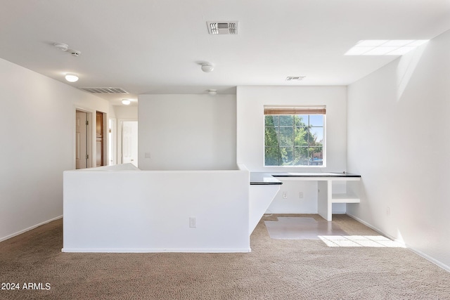 unfurnished room featuring carpet and visible vents