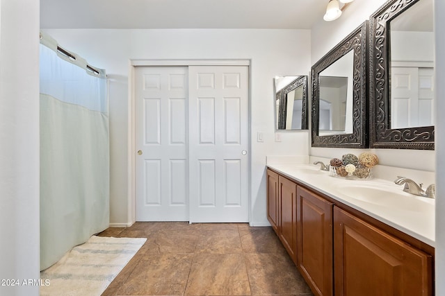 full bath featuring double vanity, a sink, and a shower with shower curtain