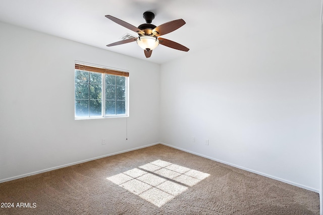 spare room with ceiling fan, carpet floors, and baseboards