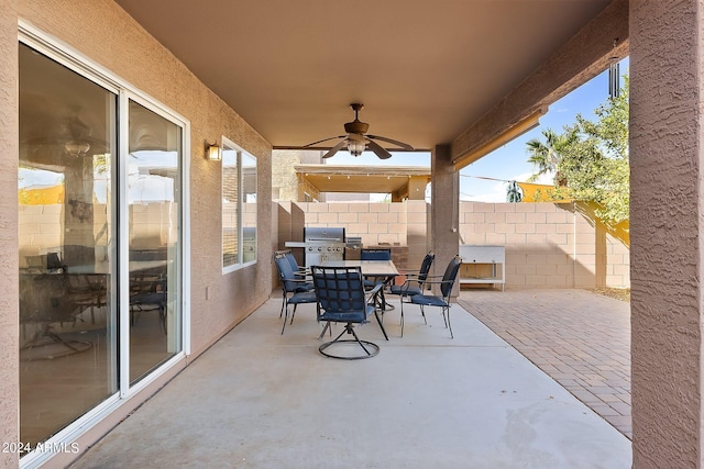 view of patio / terrace featuring outdoor dining space, fence, area for grilling, and ceiling fan