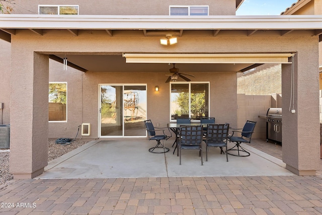 view of patio featuring outdoor dining space, grilling area, and a ceiling fan