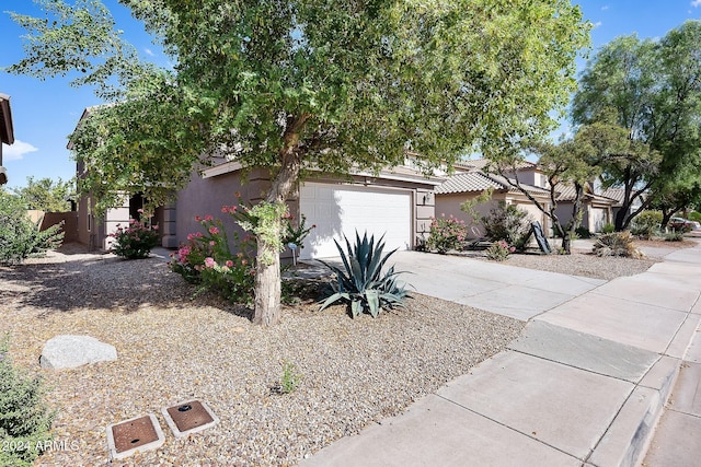 view of front of home with driveway and stucco siding