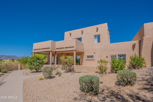 38065 N Cave Creek Rd Unit 52, Cave Creek, AZ 85331 - rear view of property featuring a balcony, a mountain view, and stucco siding