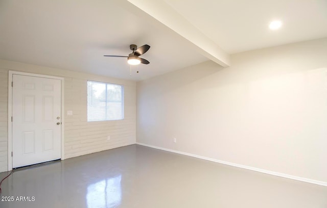 unfurnished room featuring concrete floors, ceiling fan, and beamed ceiling