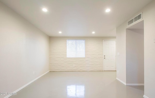 empty room with concrete flooring