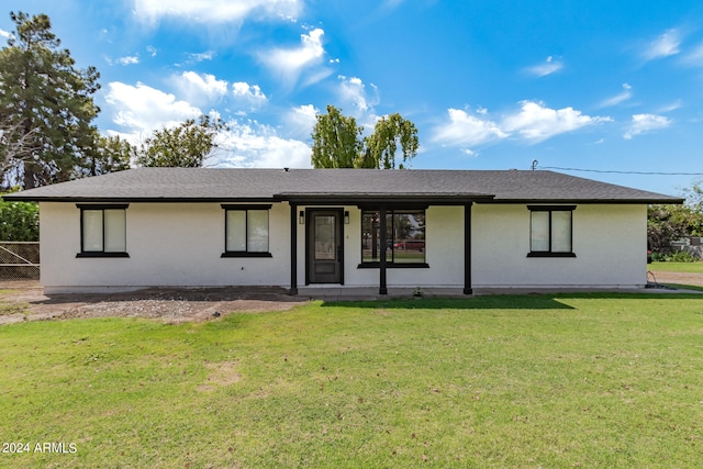 back of property featuring a yard