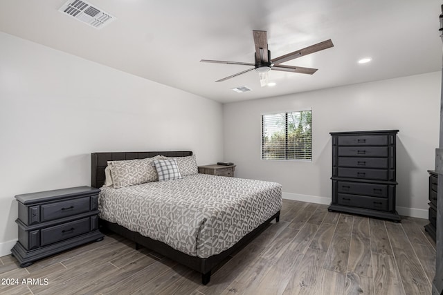 bedroom with hardwood / wood-style floors and ceiling fan