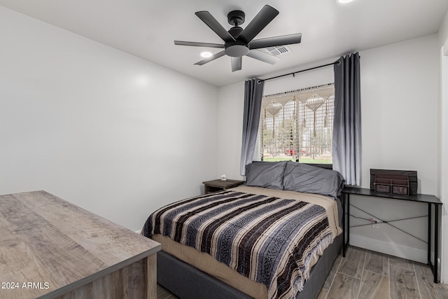 bedroom with ceiling fan and hardwood / wood-style flooring