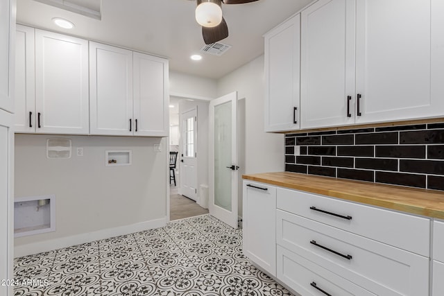 interior space featuring ceiling fan, butcher block counters, white cabinets, and tasteful backsplash